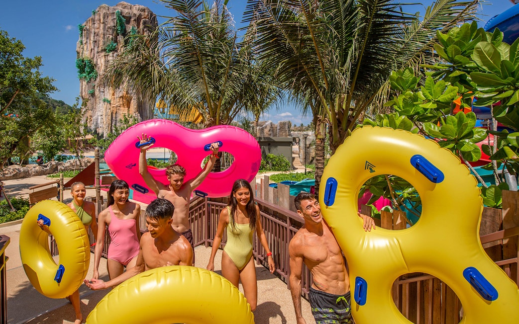 Group enjoying water park with inflatable tubes at Andamanda, Phuket.