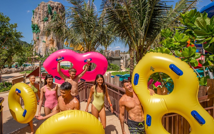 Group enjoying water park with inflatable tubes at Andamanda, Phuket.