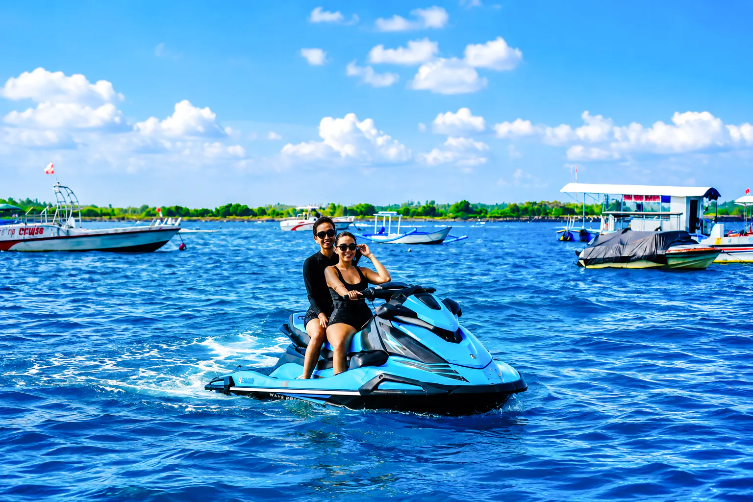 Jet skiing adventure in Tanjung Benoa, Bali with boats in the background.