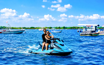 Jet skiing adventure in Tanjung Benoa, Bali with boats in the background.