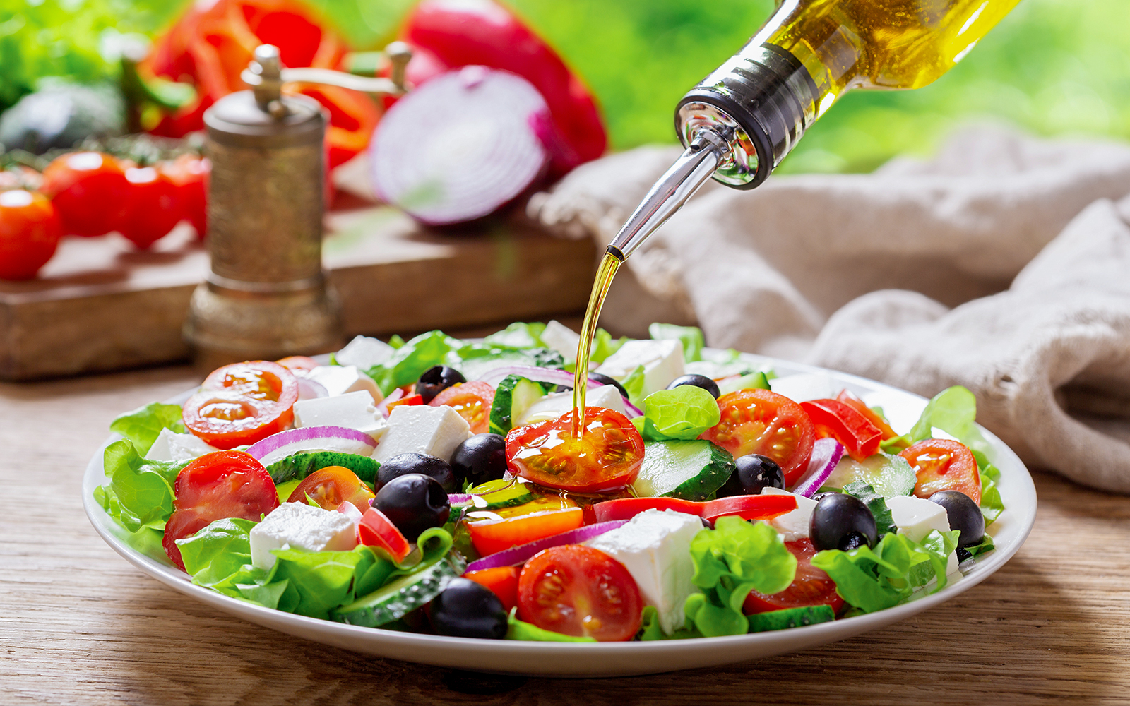 Mediterranean salad with olives, tomatoes, and feta cheese in a bowl.