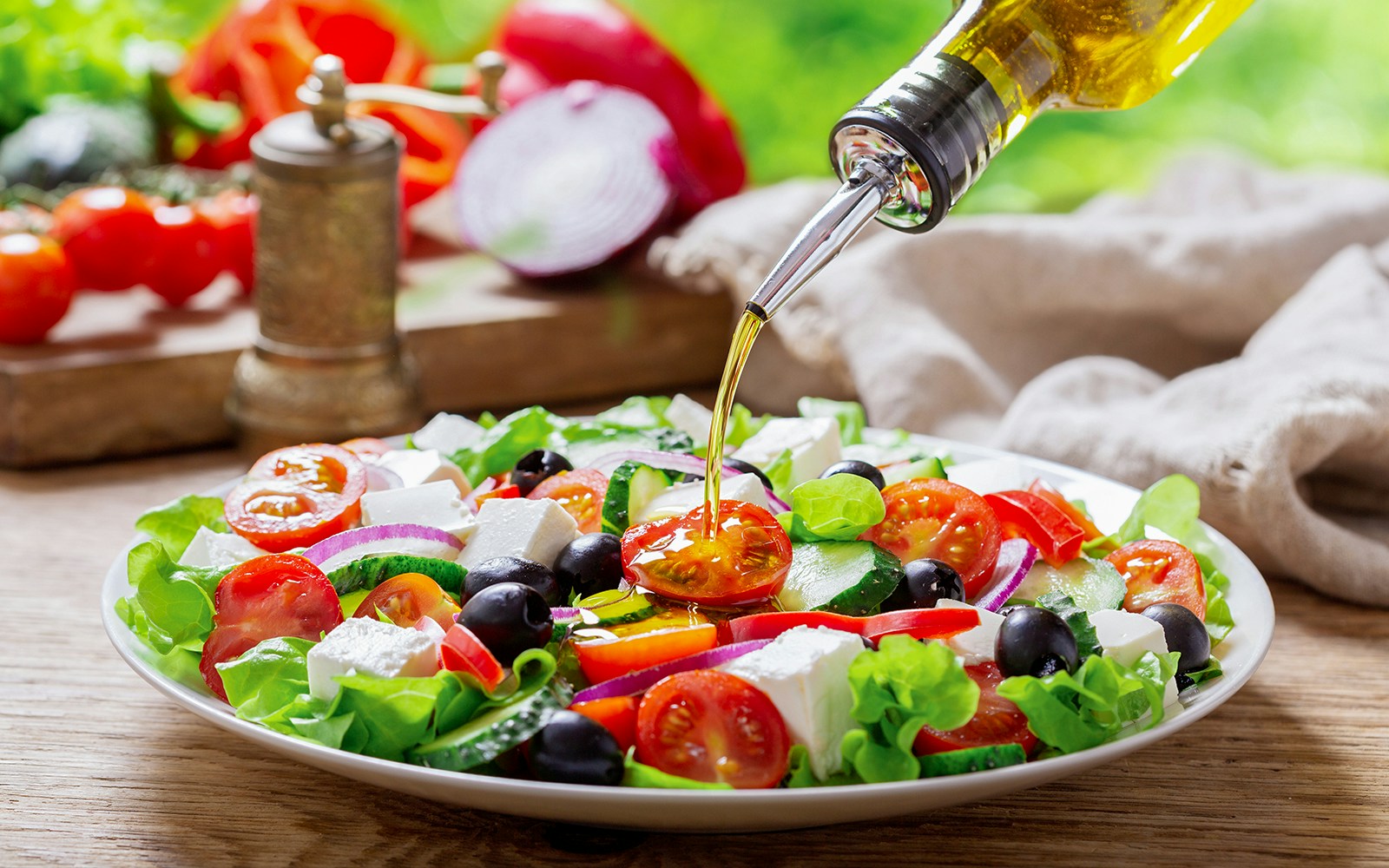 Mediterranean salad with tomatoes, olives, feta, and olive oil drizzle.