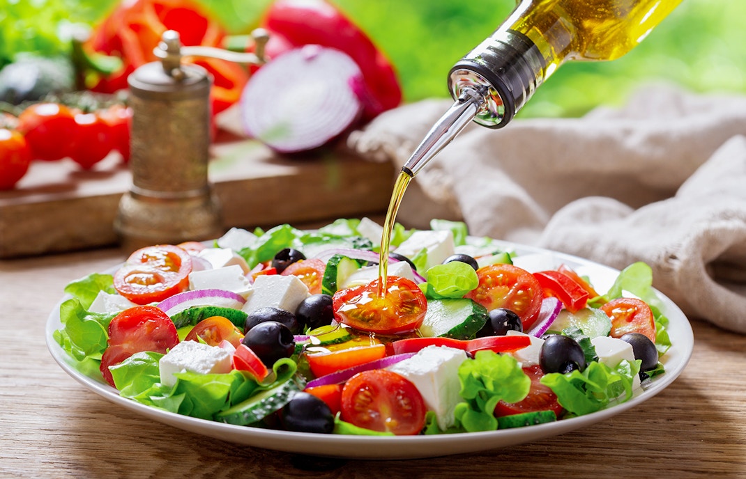 Mediterranean salad with olives, tomatoes, and feta cheese in a bowl.