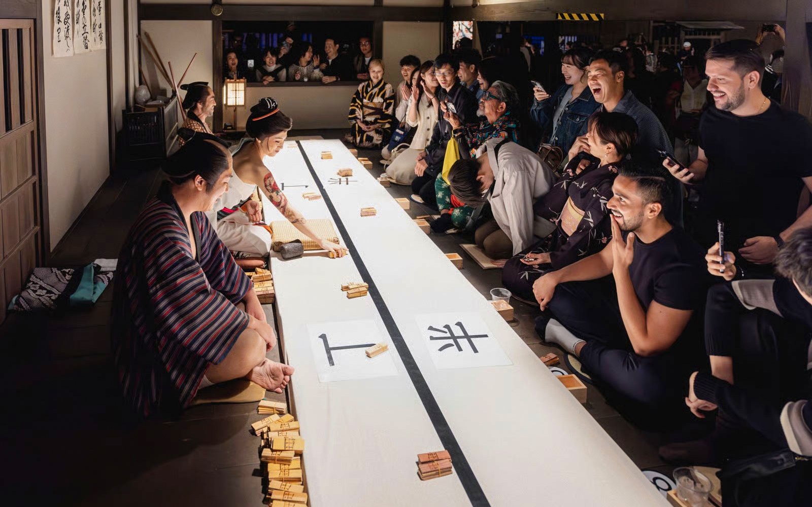 Tourists enjoying a traditional game at TOEI Kyoto Studio Park.