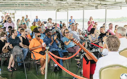 Guests enjoying live jazz music on a riverboat cruise in New Orleans.