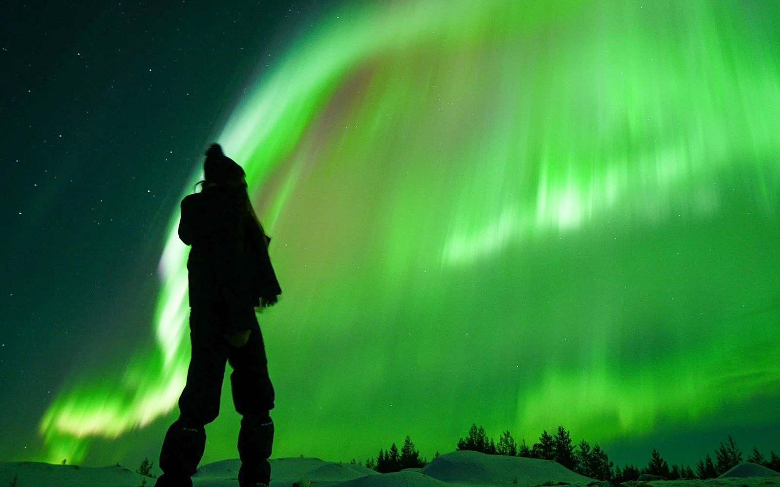 Guest viewing Northern Lights on tour with unlimited mileage and photography.
