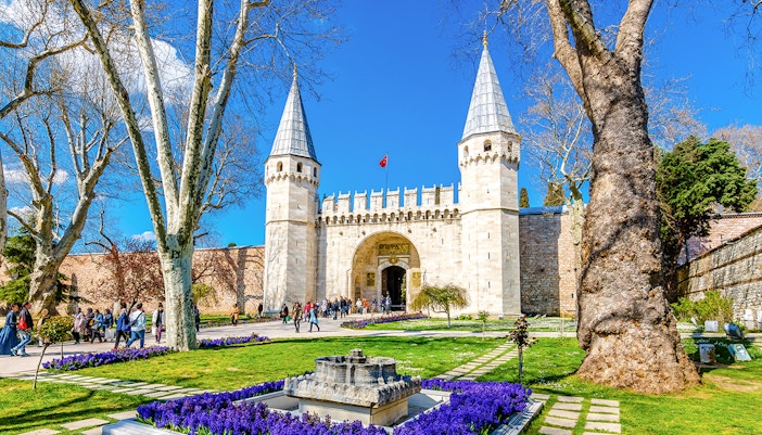 Gate of Salutation entrance at Topkapi Palace, Istanbul, with tourists exploring the historic site.