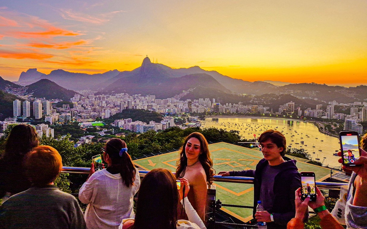 Sunset view from Sugarloaf Mountain, Rio de Janeiro, overlooking cityscape and bay.
