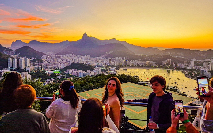 Sunset view from Sugarloaf Mountain, Rio de Janeiro, overlooking cityscape and bay.