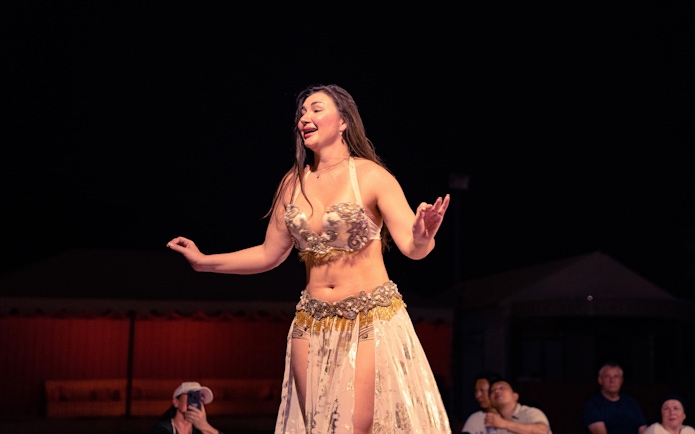 Belly dancer performing at a desert safari in Abu Dhabi at night.
