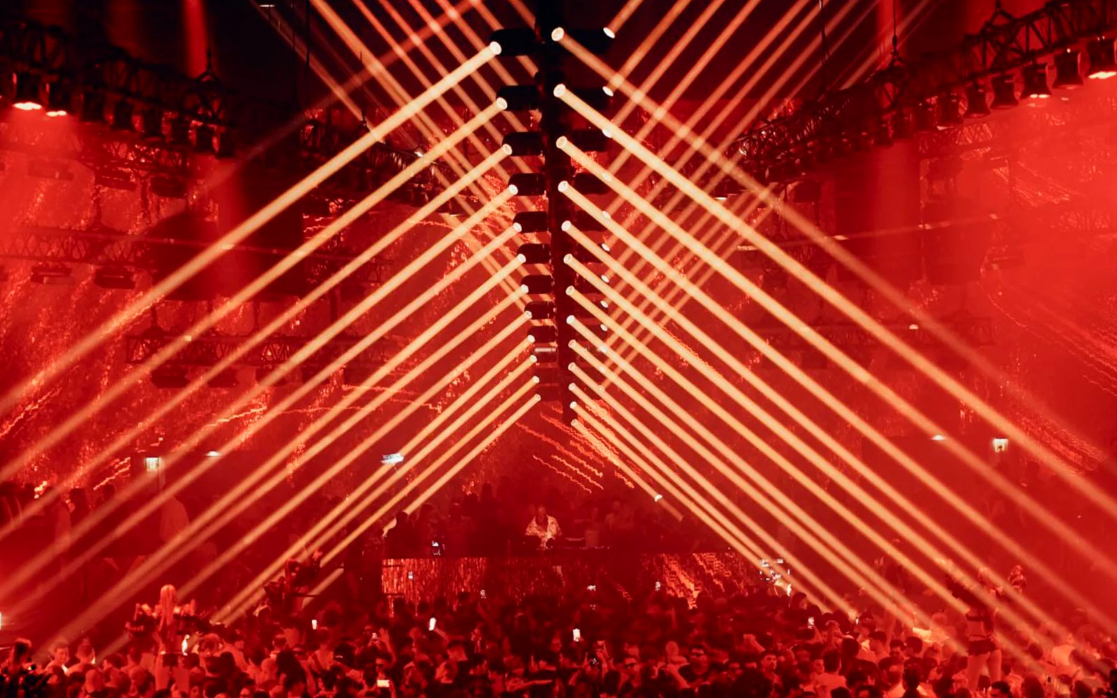 Carl Cox DJ performance with red laser lights in Ibiza nightclub.