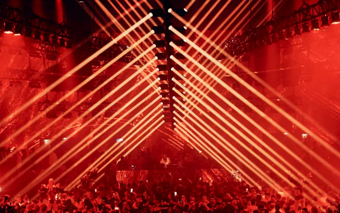 Carl Cox DJ performance with red laser lights in Ibiza nightclub.