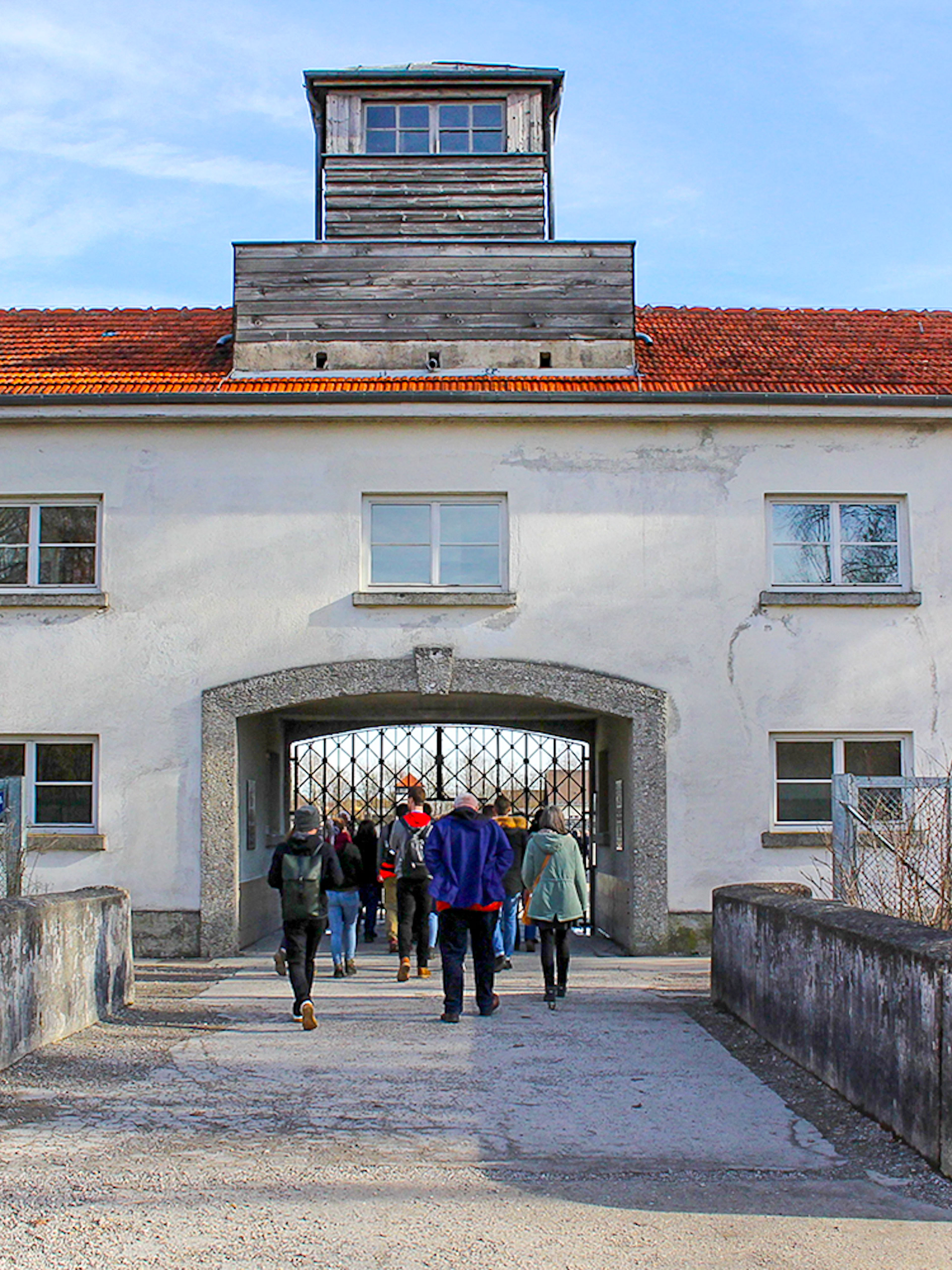 Visitors entering the gate of Dachau Concentration Camp, Germany.