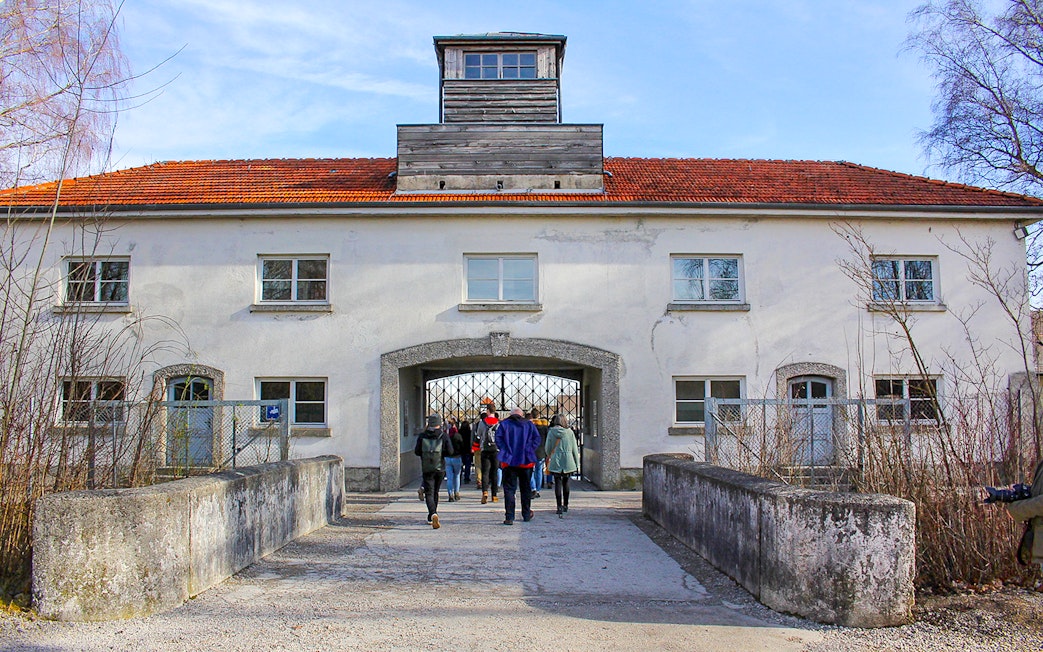 Visitors entering the gate of Dachau Concentration Camp, Germany.
