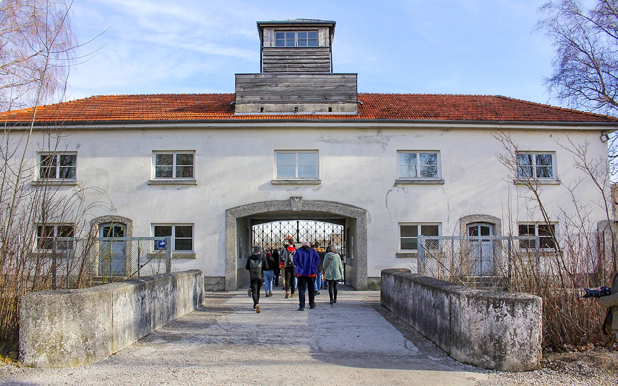 Visitors entering the gate of Dachau Concentration Camp, Germany.