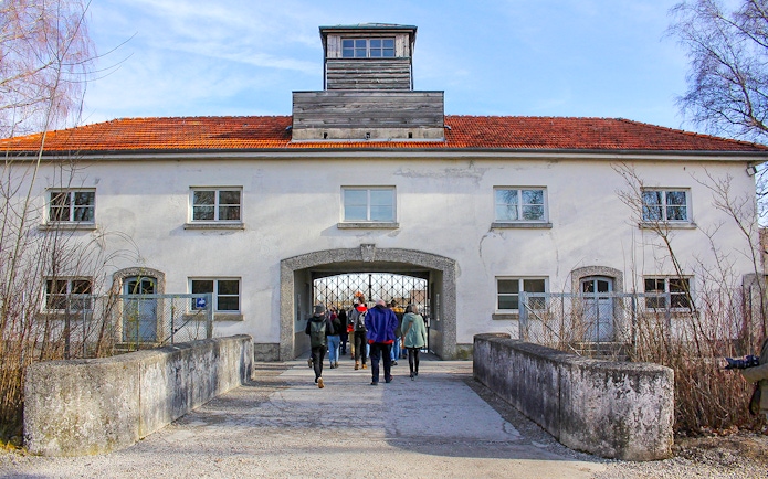 Visitors entering the gate of Dachau Concentration Camp, Germany.