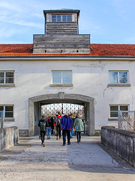 Visitors entering the gate of Dachau Concentration Camp, Germany.