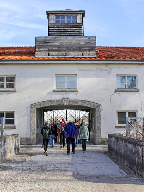 Visitors entering the gate of Dachau Concentration Camp, Germany.