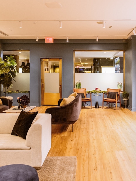 Luxurious lounge area at Top of the Rock Observation Deck with modern decor and seating.