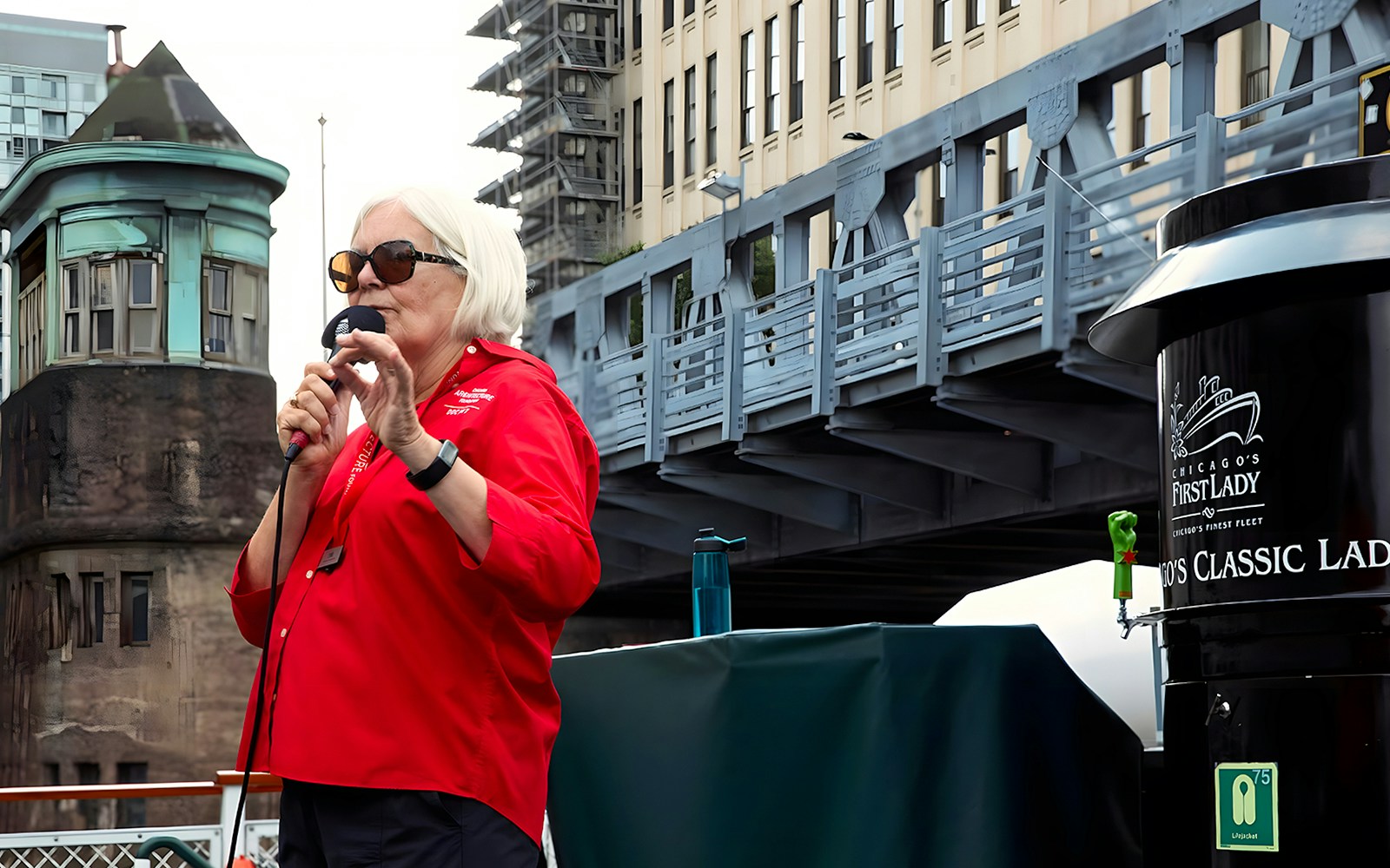 Guide speaking on the 'Chicago First Lady' cruise with city architecture in the background.