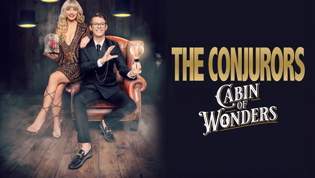 The Conjurors performing magic in a dimly lit room with vintage decor.