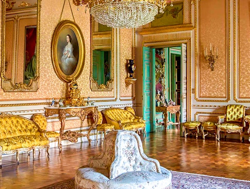 Elegant room in Musei Reali, Turin, featuring ornate chandelier and antique furniture.