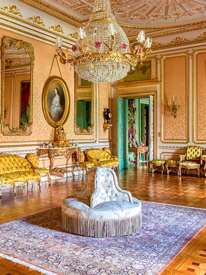 Elegant room in Musei Reali, Turin, featuring ornate chandelier and antique furniture.