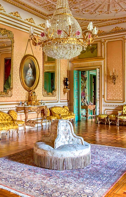 Elegant room in Musei Reali, Turin, featuring ornate chandelier and antique furniture.
