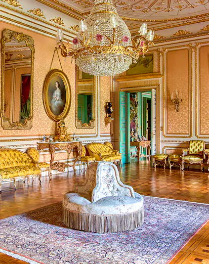 Elegant room in Musei Reali, Turin, featuring ornate chandelier and antique furniture.