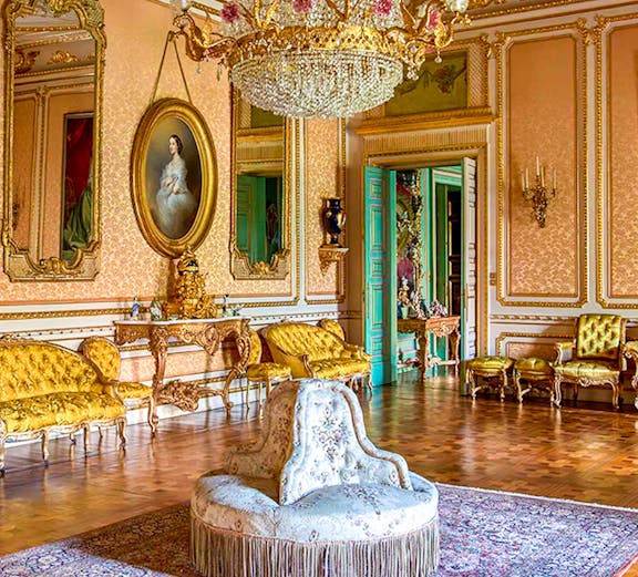 Elegant room in Musei Reali, Turin, featuring ornate chandelier and antique furniture.