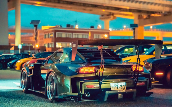 Modified cars at Daikoku PA Car Meeting in Tokyo, featuring a prominent rear spoiler.