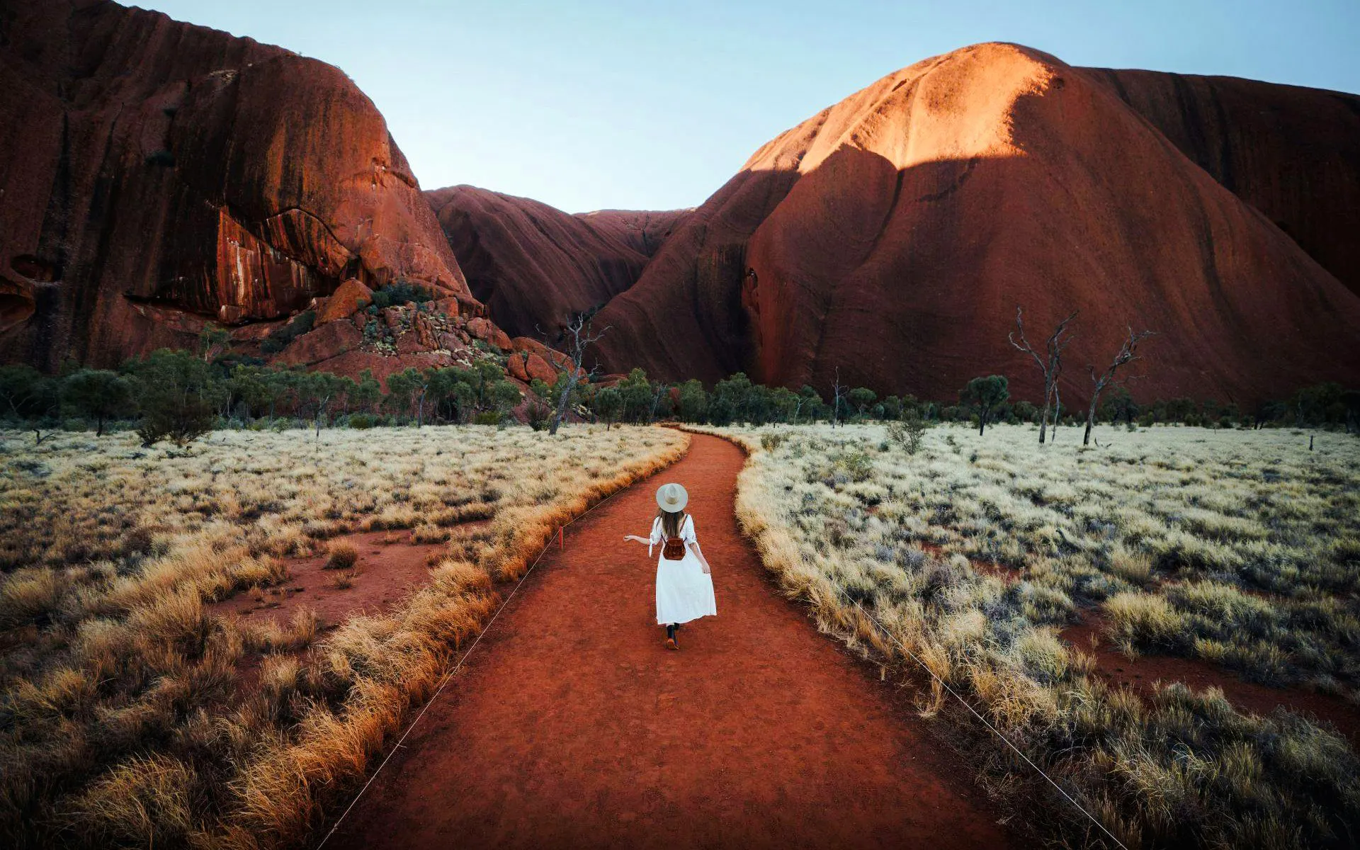 Tourist walking along a path in Uluru-Kata Tjuṯa National Park, Australia.