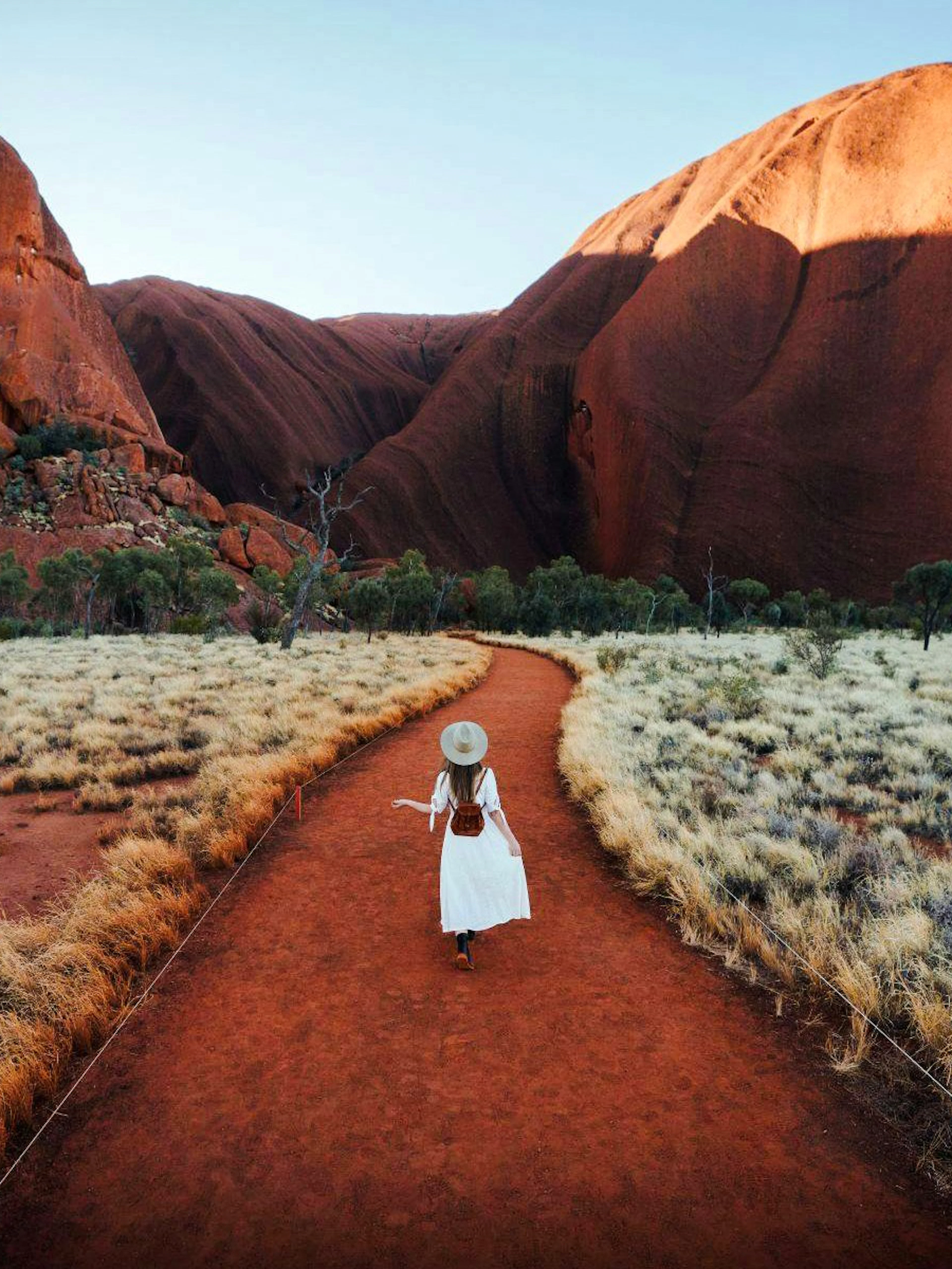 Tourist walking along a path in Uluru-Kata Tjuṯa National Park, Australia.