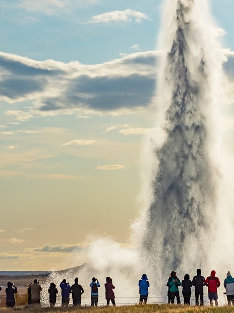 Tourists watching Strokkur geyser erupt in Iceland's Golden Circle.