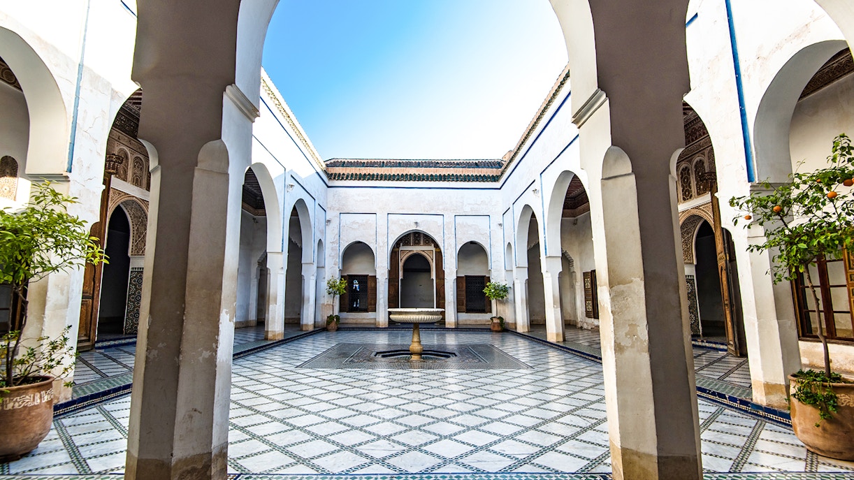 Bahia Palace courtyard with arches and fountain in Marrakech, Morocco.