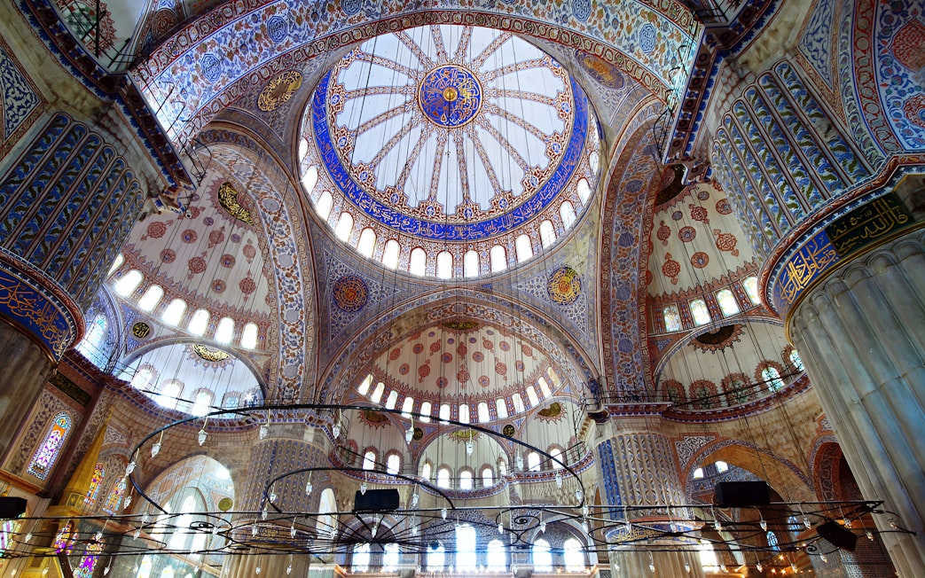 Interior view of the Blue Mosque domes in Istanbul, showcasing intricate designs and arches.
