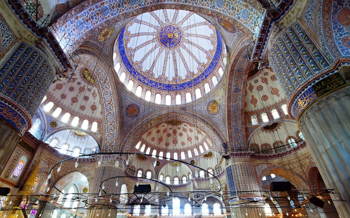 Interior view of the Blue Mosque domes in Istanbul, showcasing intricate designs and arches.