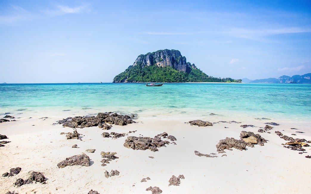 Ko Thap island with turquoise waters and a boat, part of Krabi 4 island day trip.