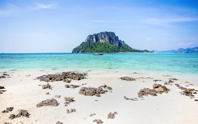 Ko Thap island with turquoise waters and a boat, part of Krabi 4 island day trip.