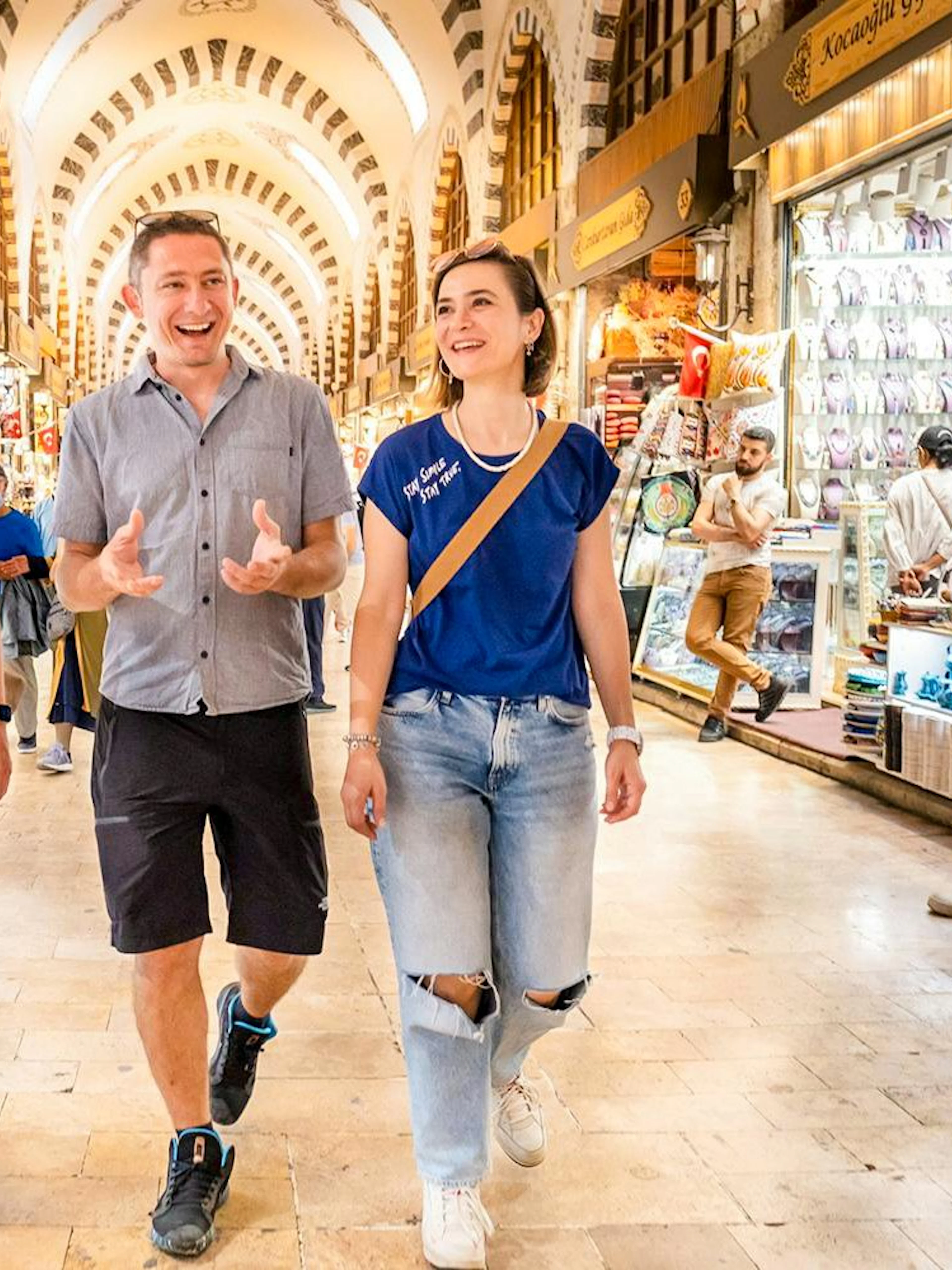 Visitors exploring a bustling market on the Taste of Two Continents Food Tour.