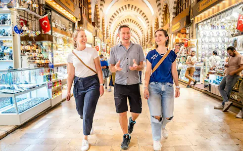 Visitors exploring a bustling market on the Taste of Two Continents Food Tour.