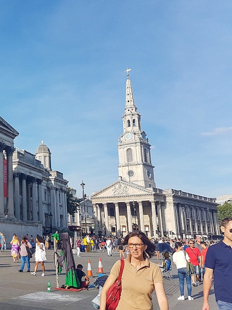 National Gallery and St Martin-in-the-Fields church in London with tourists exploring the area.