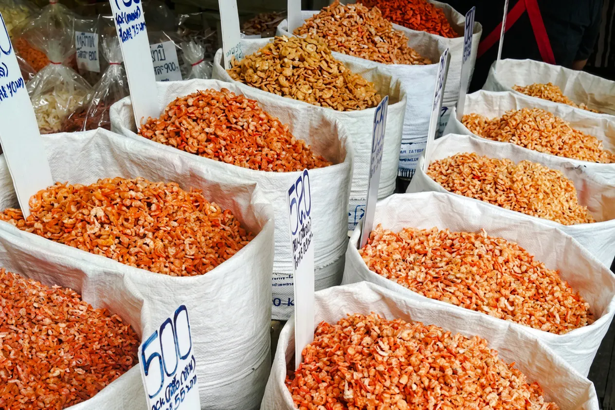 Bags of dried shrimp displayed at a market stall in Bangkok's Chinatown.