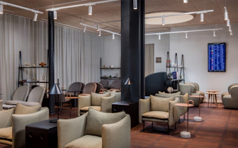 Aspire Lounge seating area with modern chairs and tables at Copenhagen Kastrup Airport Terminal 2.