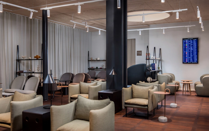Aspire Lounge seating area with modern chairs and tables at Copenhagen Kastrup Airport Terminal 2.