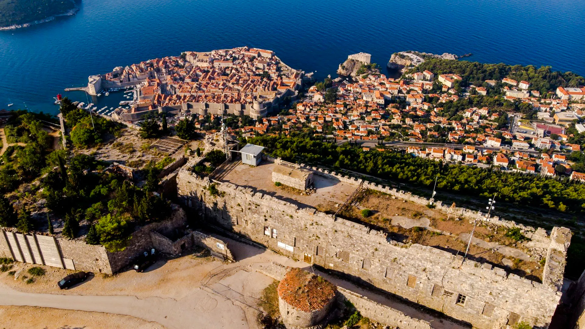 Aerial view of Dubrovnik's Old Town and fortifications, highlighting historical architecture.
