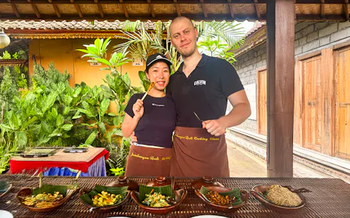 Participants enjoying Jambangan Bali Cooking Class in Ubud with traditional dishes.