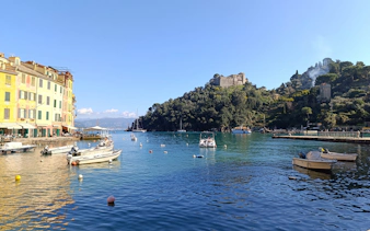 Portofino harbor with colorful buildings and boats on the water.