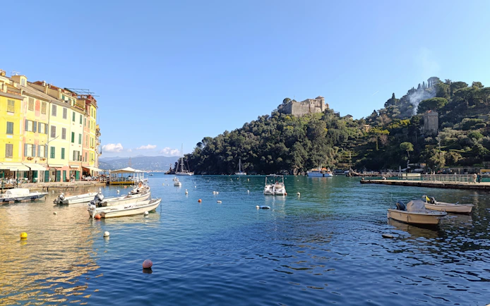 Portofino harbor with colorful buildings and boats on the water.