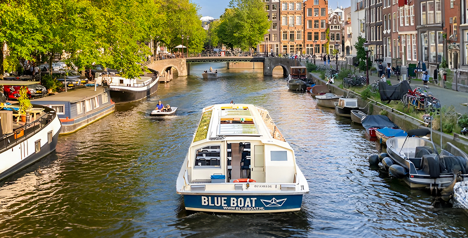 Amsterdam canal cruise with views of historic buildings and iconic bridges.
